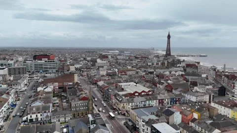 Blackpool seaside resort seafront part of town low Panning drone aerial Stock Footage 336309435