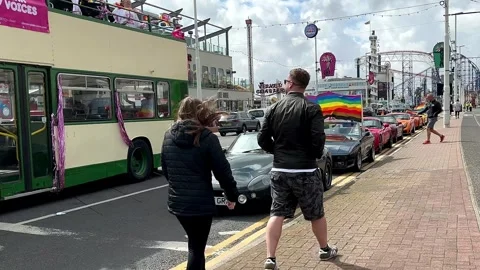 Blackpool, UK 08 June 2024: Summer rainbow Pride_ Vintage Trams by the seaside. Stock Footage 277105250
