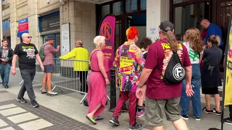 Blackpool, UK 2025 Aug, 10: Rebellion Festival attendees at Box Office entrance Stock Footage 314612962