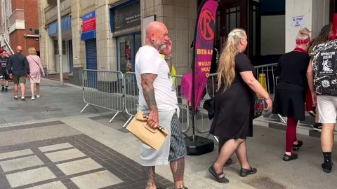 Blackpool, UK 2025 Aug, 10: Rebellion Festival attendees at Box Office entrance Stock Footage 314612969