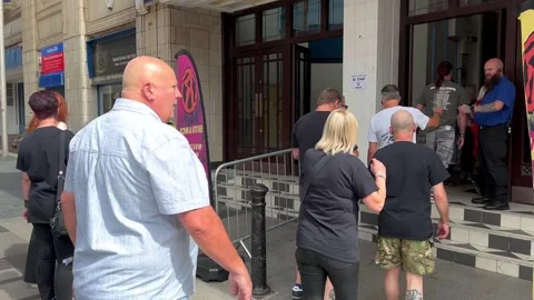 Blackpool, UK 2025 Aug, 10: Rebellion Festival attendees at Box Office entrance. Stock Footage 314612981