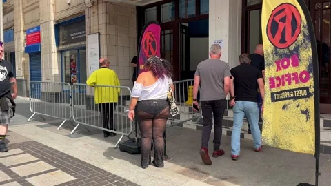 Blackpool, UK 2025 Aug, 10: Rebellion Festival attendees at Box Office entrance Stock Footage 314612998