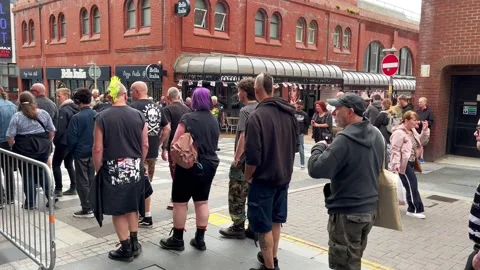 Blackpool UK 2025 Aug 10: Rebellion Punks queuing in line. 4K video Video stock 314718917