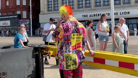 Blackpool, UK. 2025 Aug, 11: Colourful Punks on the seafront promenade. 4k video Stock Footage 314642102
