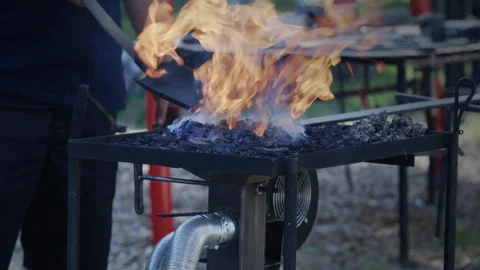 Blacksmith Adding Coal And Water To Forge Stock Footage 338277749
