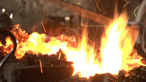 Blacksmith adjusts the bonfire. Stock Footage 49396525