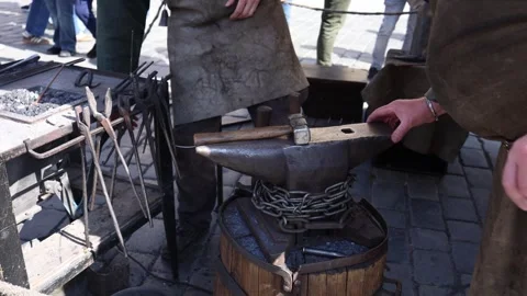 Blacksmith anvil and tools outdoor market craft scene Stock Footage 331812139