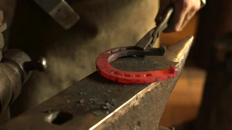 Blacksmith on the Anvil Forging a Hot Horseshoe. Video stock 271153579