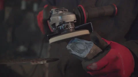Blacksmith applying polishing paste on grinder. Damascus steel knife. Stock Footage 194485541