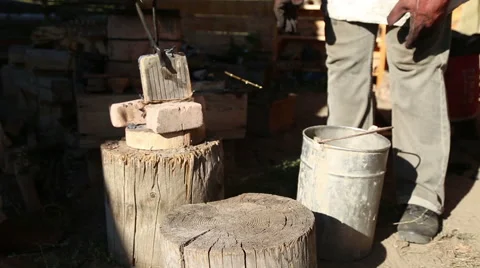 The blacksmith with assistant with the tongs shift form for smelting Stock Footage 54688612