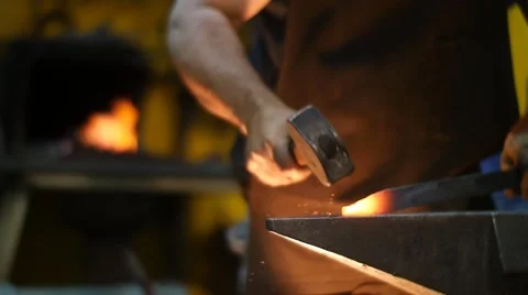 Blacksmith Banging a Hot Metal in a Workshop Slow Motion Stock Footage 55449005