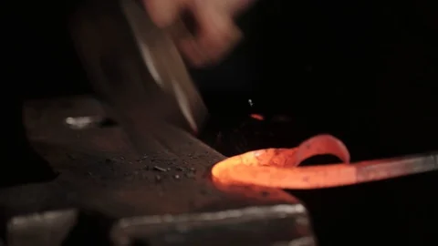 The blacksmith beats the metal with a hammer Video stock 128688343