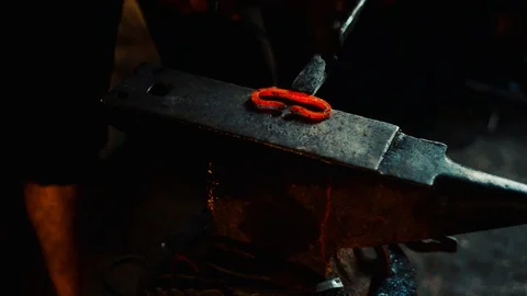 Blacksmith bend red-hot blank on on special anvil Stock-Footage 127882720