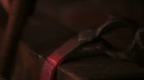 Blacksmith bending and cutting a piece of iron by hand, closeup Stock Footage 39020434