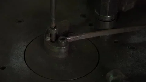 Blacksmith bends metal rod on automatic anvil into spiral, decorative ornament Stock Footage 239096767