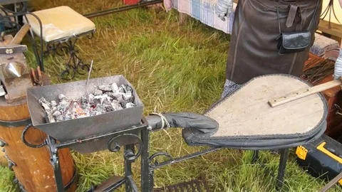 Blacksmith blows coals Stock Footage 78527979