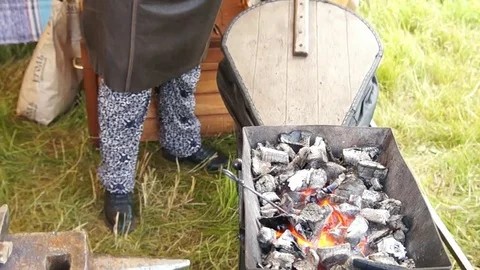 Blacksmith blows coals Stock Footage 78528007