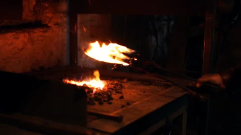Blacksmith burns the item in the stove 스톡 동영상 100156697