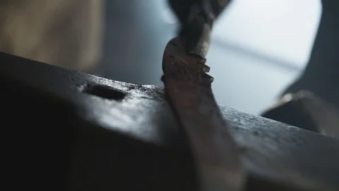 Blacksmith cleaning iron a with wire brush Stock Footage 92058820