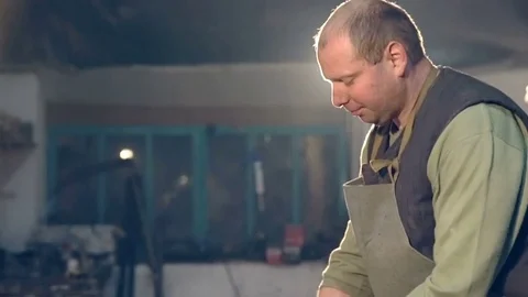 The blacksmith compares detail of layout Stock Footage 76426270