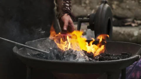 Blacksmith Cranks Forge Blower to Stoke Fire Stock Footage 320074158