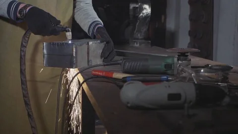 Blacksmith cuts iron details via plasma cutter at his workshop, slow motion. Stock Footage 83765798