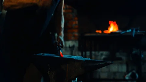Blacksmith forge and bend blank on anvil and fire in the furnace on background Stock-Footage 127882645
