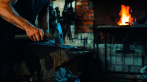 Blacksmith forge and bend blank on anvil and fire in the furnace on background Stock-Footage 127882745