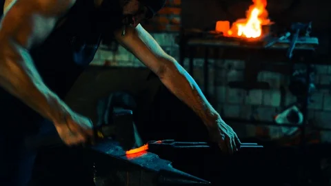 Blacksmith forge blank on anvil and fire in the furnace on background Stock-Footage 127882626