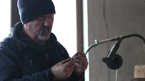 Blacksmith forges and tempering metal horseshoe in jar with water at forge Stock Footage 168970901