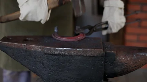 Blacksmith Forges a Horseshoe in a Smithy Stock Footage 46357956