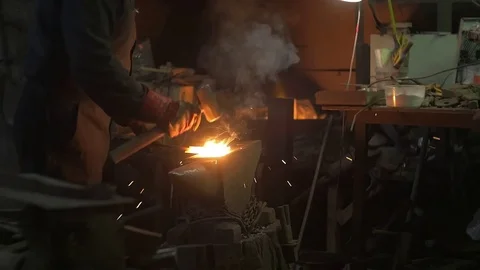 Blacksmith forges iron hammer Stock Footage 72693291
