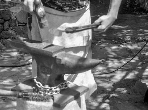 The blacksmith forges the knives with blows Stock Photos