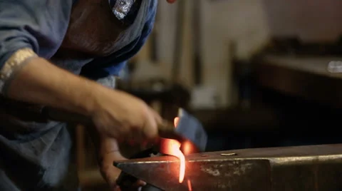Blacksmith forges the metal on the anvil Stock Footage 67734590