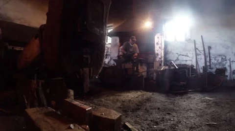 Blacksmith forges metal in the old smithy in the foreground hammer Stock Footage 46420478