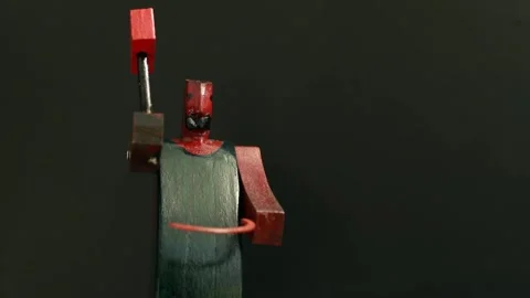 Blacksmith forges with a red hammer, stop motion Stock Footage 296604744