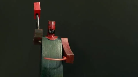 Blacksmith forges with a red hammer, stop motion Stock Footage 296746703