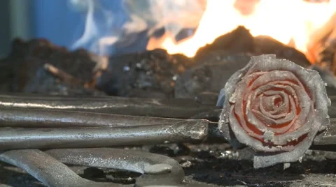 Blacksmith forges a red-hot metal rose Stock Footage 49211027