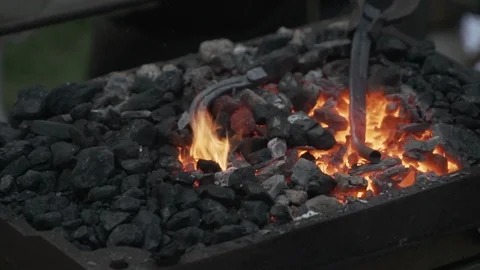 Blacksmith Forging a fire for heating metal, slow motion Stock Footage 92467867