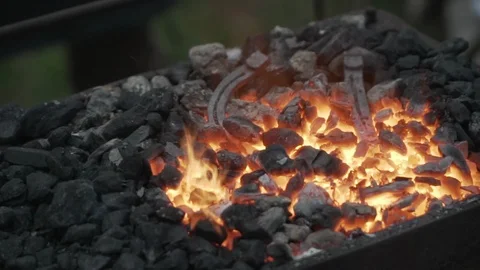 Blacksmith Forging a fire for heating metal, slow motion Stock Footage 92467922