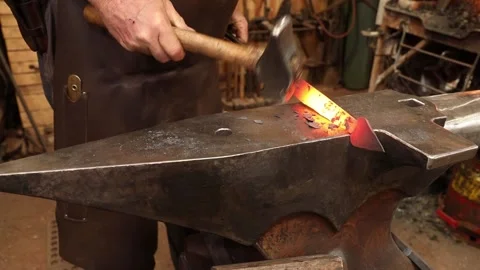 Blacksmith forging a hinge on the anvil Stock Footage 153495687