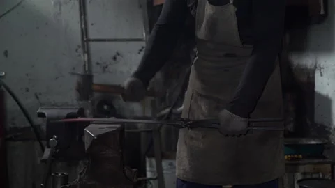 Blacksmith Forging Hot Iron in a Workshop 動画素材 132968560