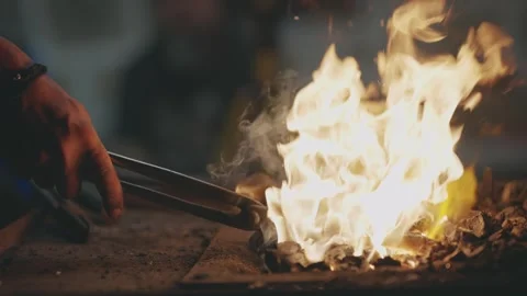 Blacksmith Forging Hot Metal in Fire with Tongs Video stock 339751458