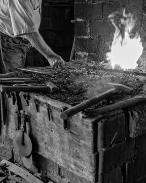 Blacksmith Forging Hot Metal in Rustic Forge Workshop Stock Photos