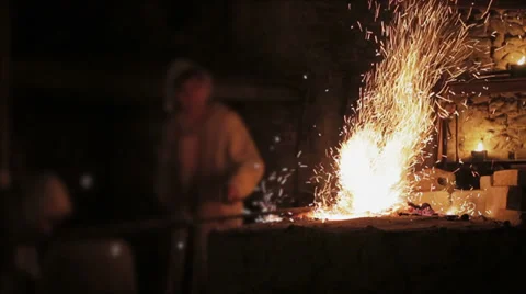 Blacksmith forging a iron sword Stock Footage