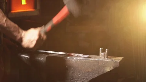 Blacksmith forging metal in slow motion Stock Footage 77384180