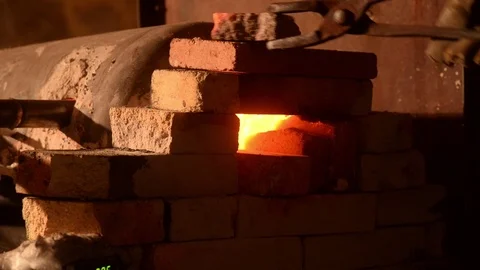 Blacksmith forging metal in a workshop Stock Footage 127360824