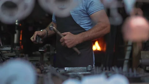 Blacksmith forging the product with hammer Stock Footage 146851546