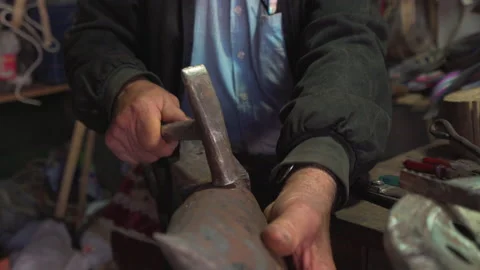 Blacksmith forging the product with hammer Stock Footage 146968415