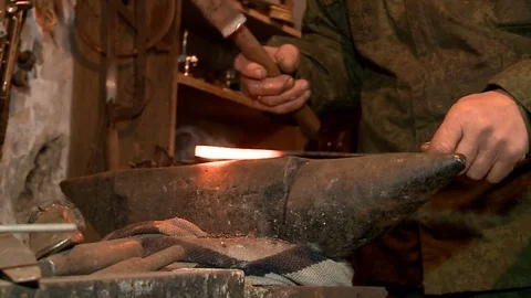 Blacksmith forging red hot iron on anvil closeup Stock Footage 75159743